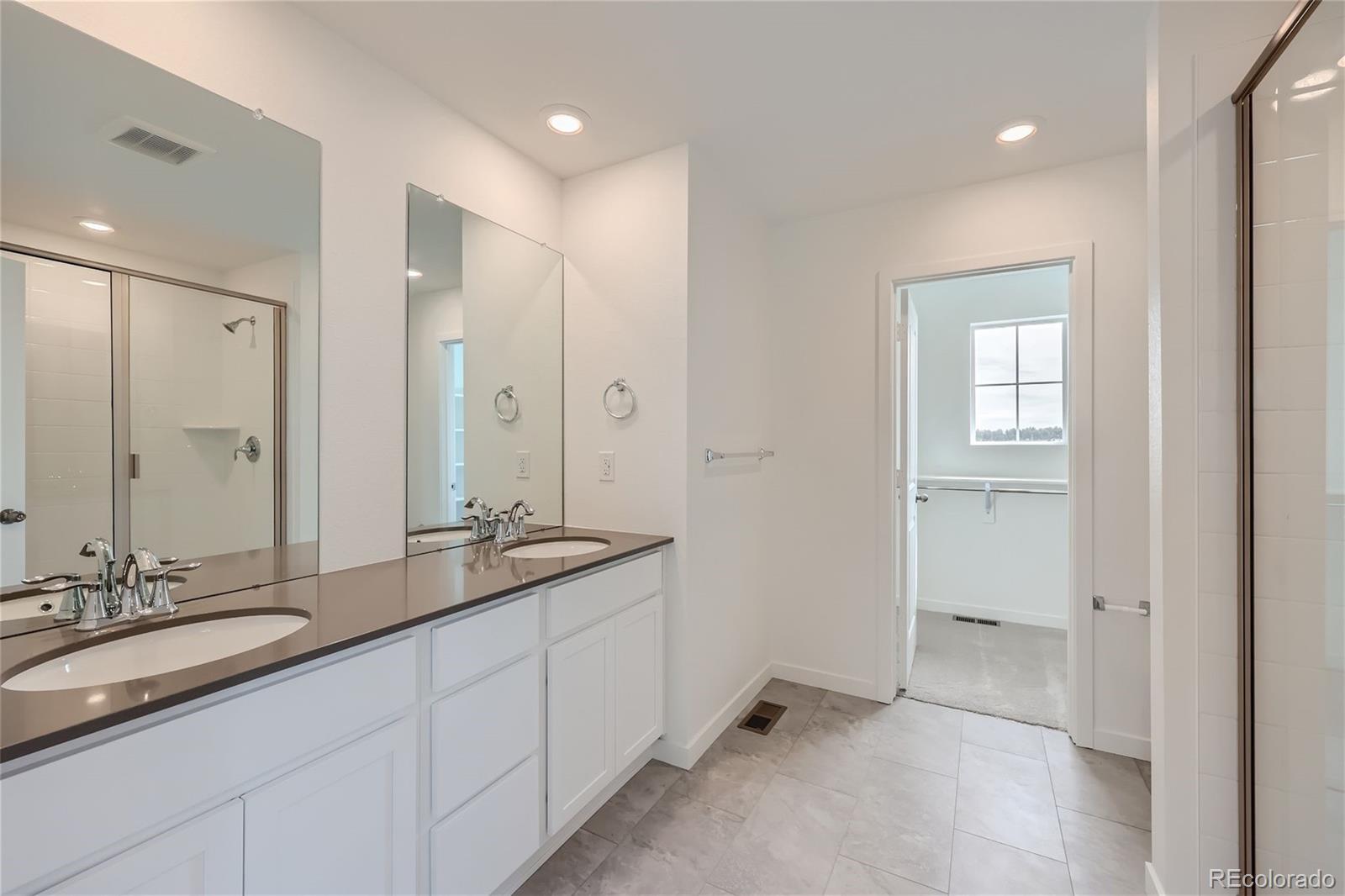 864 Yankee Boy Loop Elizabeth, CO 80107 - Photo 16 of 36 a bathroom with double sink and a mirror