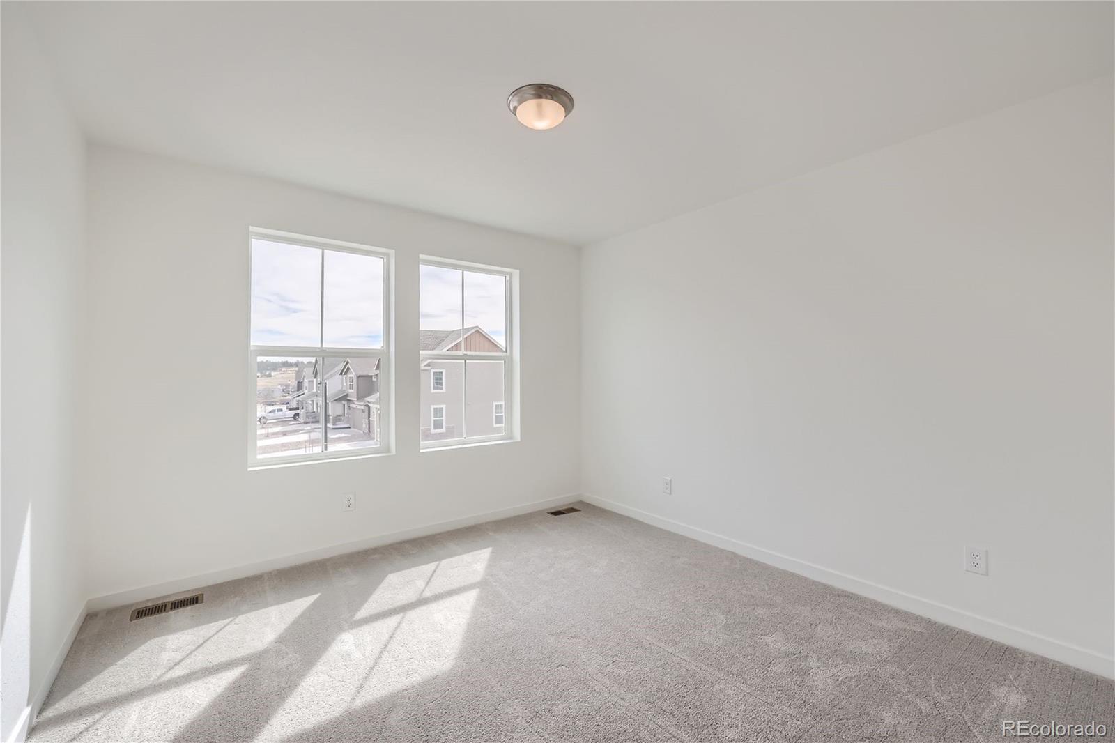 864 Yankee Boy Loop Elizabeth, CO 80107 - Photo 19 of 36 an empty room with a window