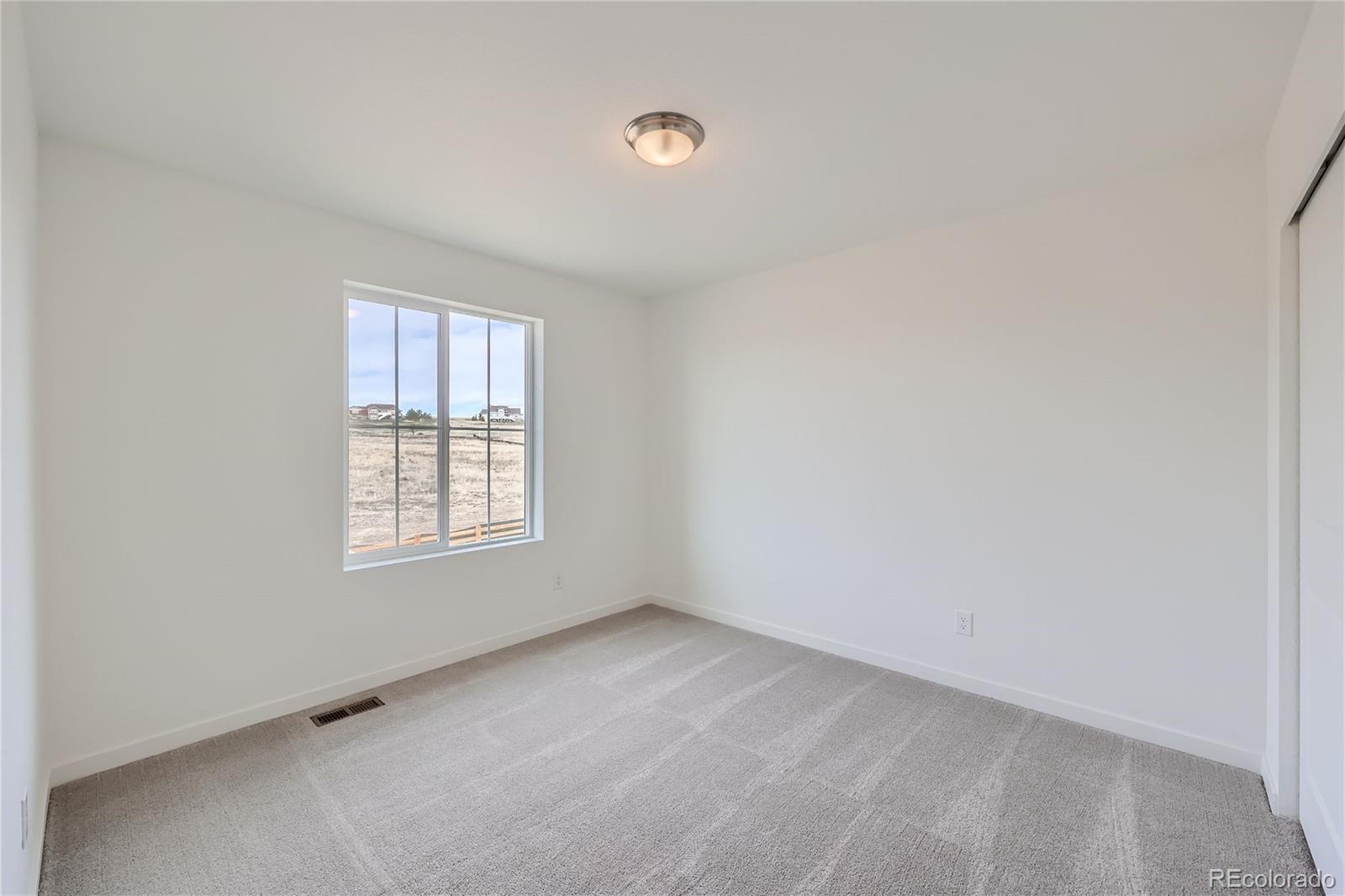 864 Yankee Boy Loop Elizabeth, CO 80107 - Photo 20 of 36 an empty room with windows