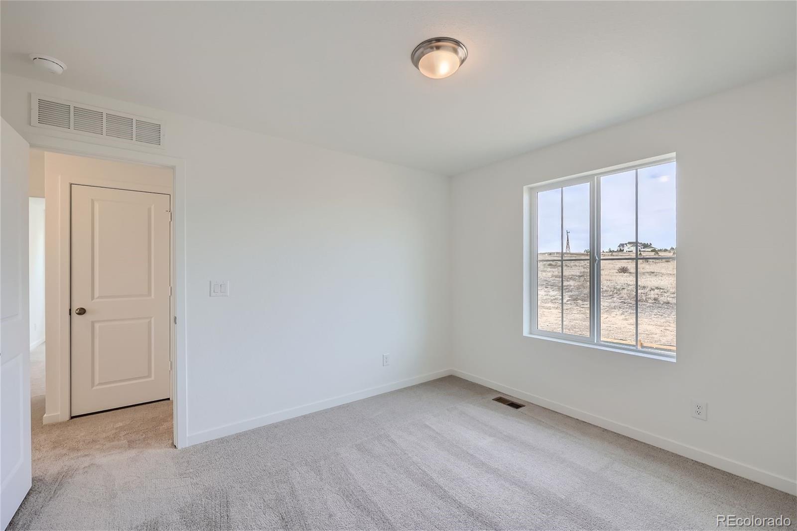864 Yankee Boy Loop Elizabeth, CO 80107 - Photo 21 of 36 an empty room with windows