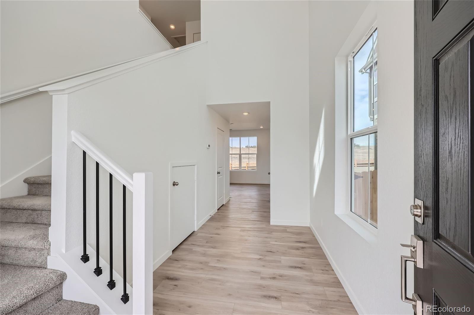 864 Yankee Boy Loop Elizabeth, CO 80107 - Photo 4 of 36 a view of a hallway with wooden floor and staircase