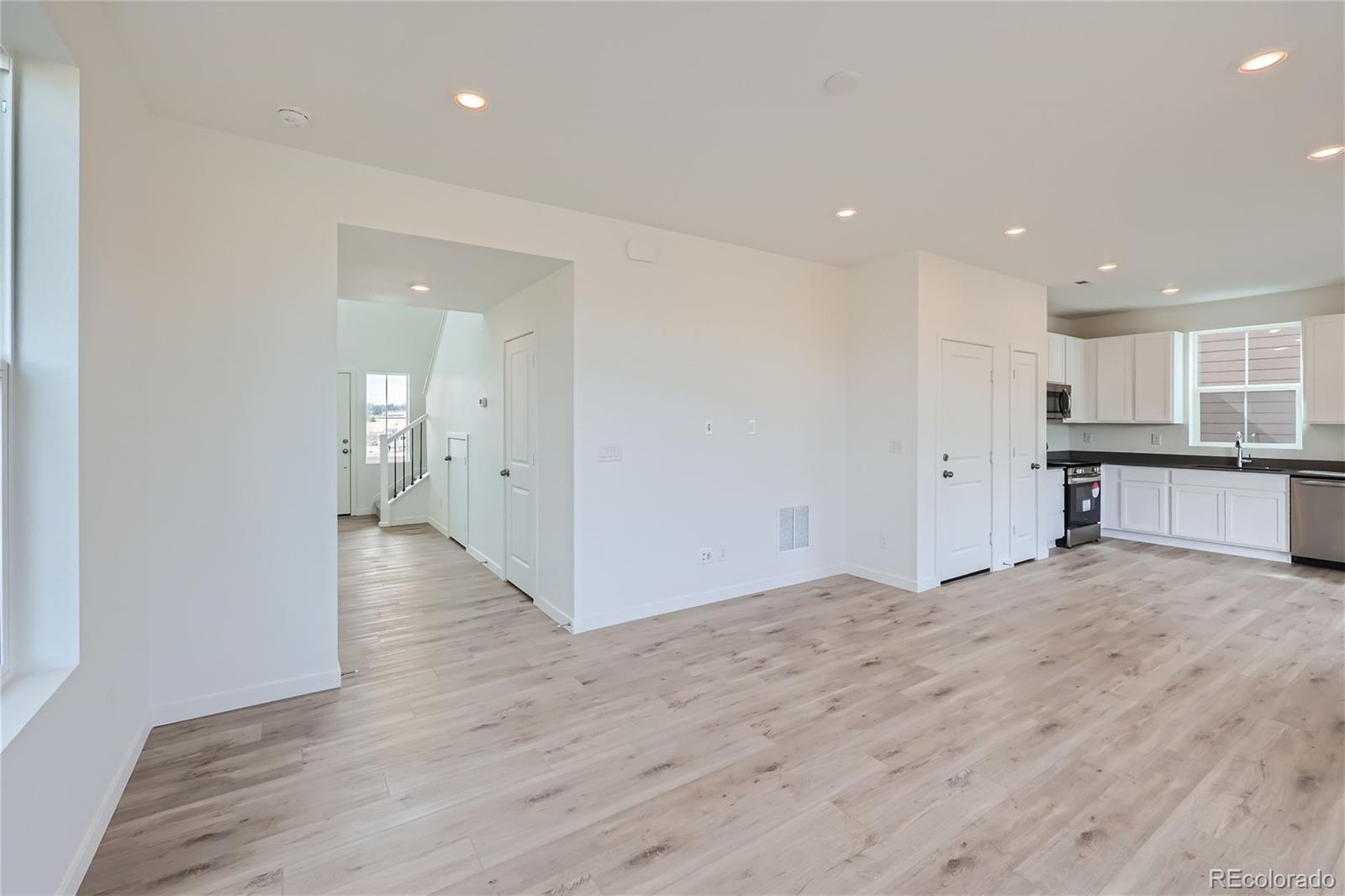 864 Yankee Boy Loop Elizabeth, CO 80107 - Photo 6 of 36 a view of a kitchen with wooden floor and windows