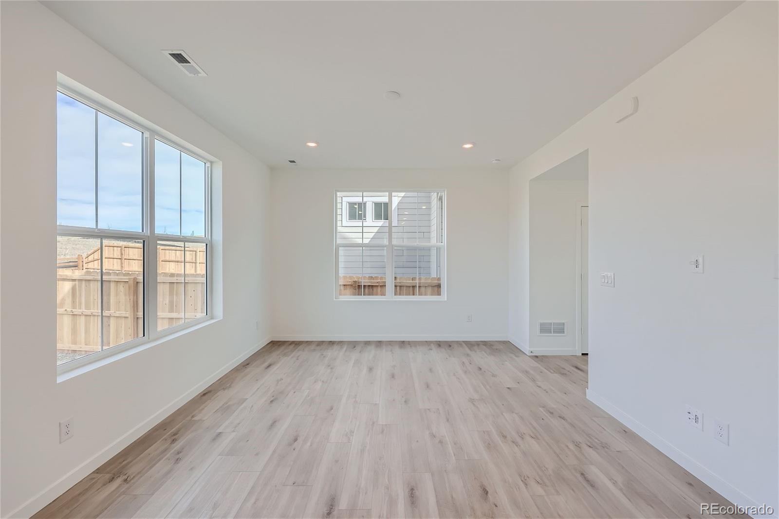864 Yankee Boy Loop Elizabeth, CO 80107 - Photo 8 of 36 a view of an empty room with wooden floor and a window