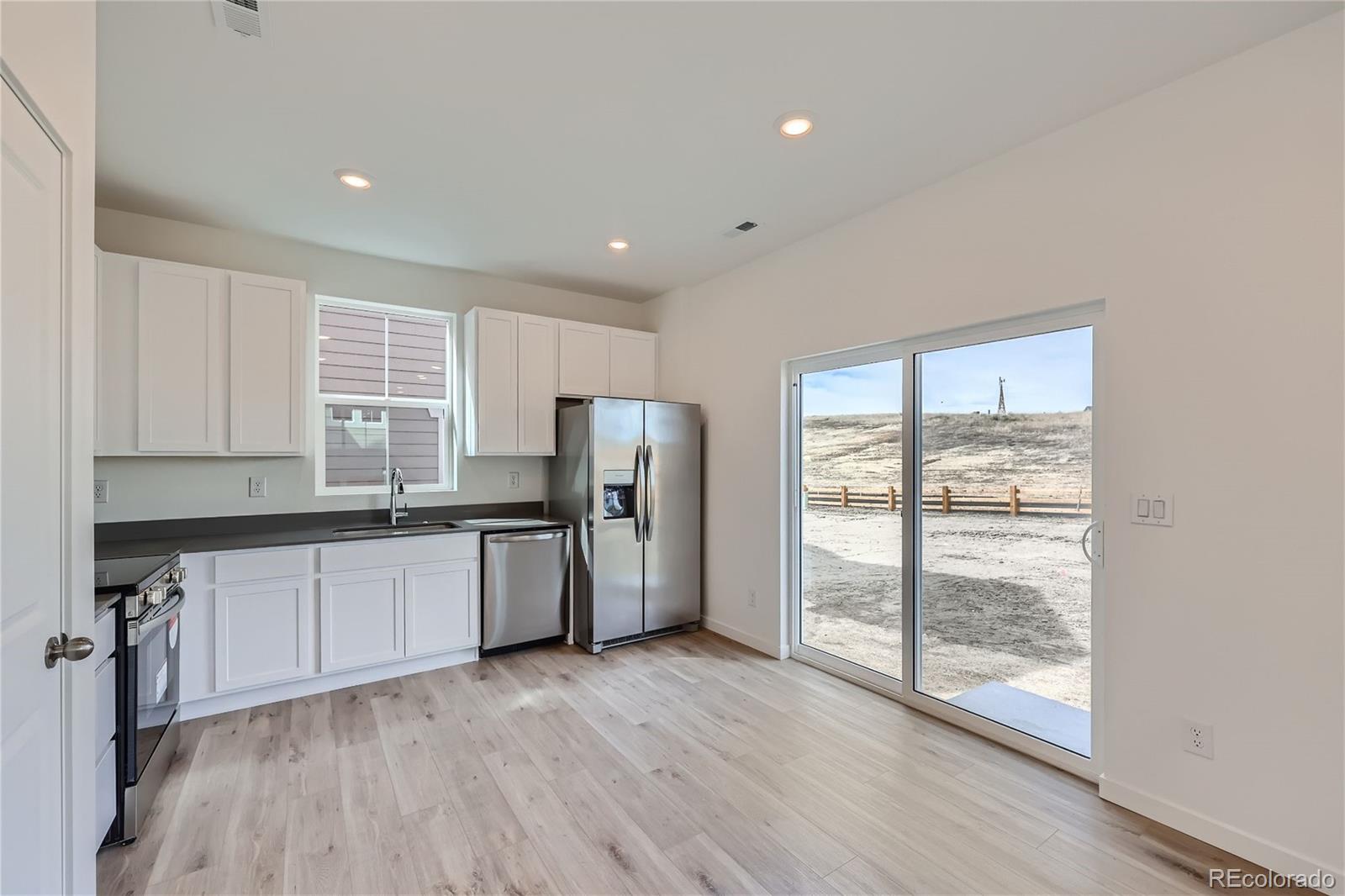 864 Yankee Boy Loop Elizabeth, CO 80107 - Photo 10 of 36 a kitchen with stainless steel appliances granite countertop a refrigerator and wooden cabinets