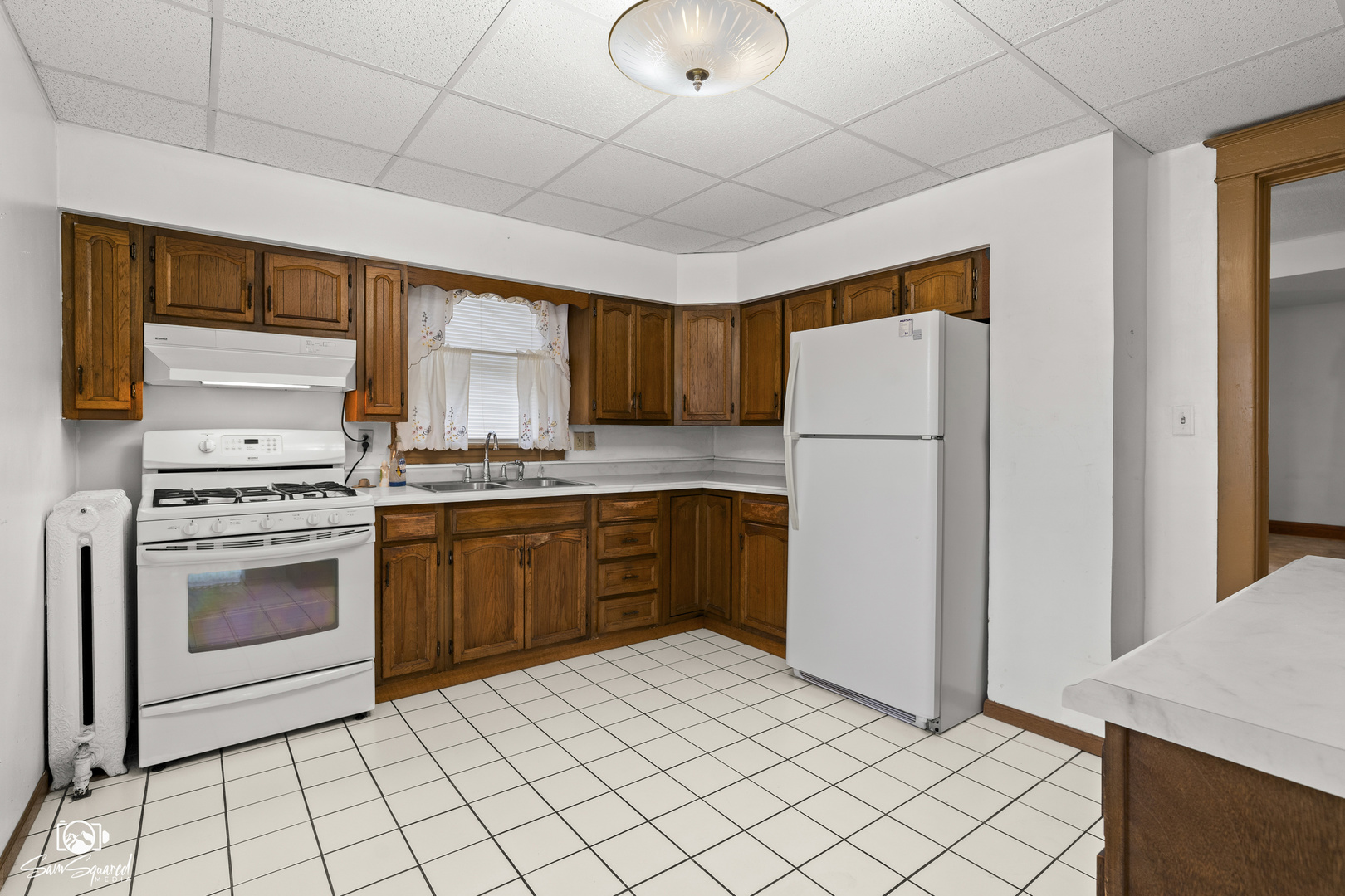 276 West 2nd Street Manteno, IL 60950 - Photo 8 of 20 a kitchen with a stove a sink and a refrigerator