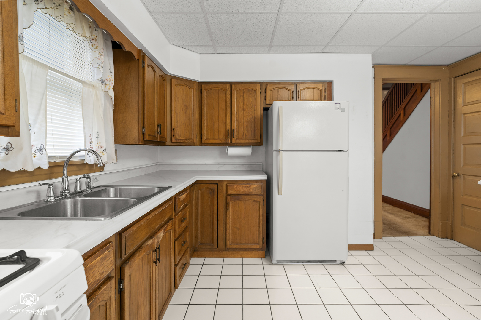 276 West 2nd Street Manteno, IL 60950 - Photo 9 of 20 a kitchen with a refrigerator a stove a sink and a counter top space