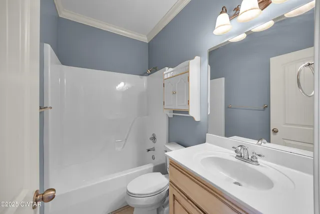 a view of an empty room with a chandelier fan