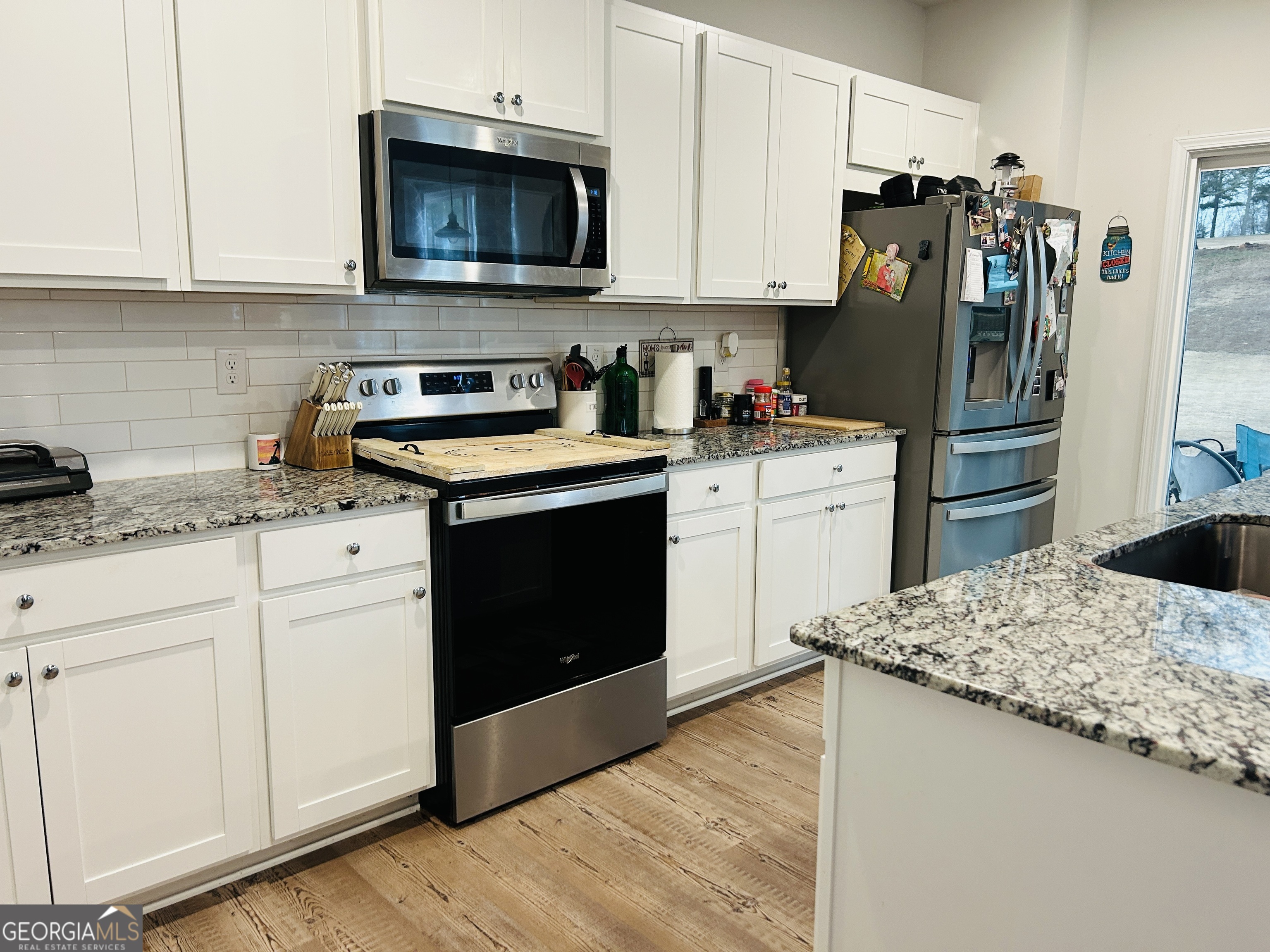 151 Sweet Briar Way Homer, GA 30547 - Photo 11 of 32 a kitchen with granite countertop a refrigerator stove and sink