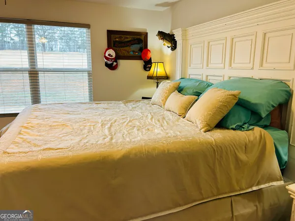 a bedroom with a bed and window