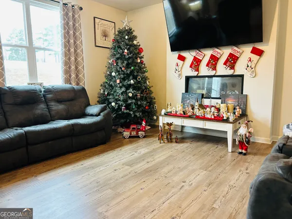 a living room with furniture and a bed