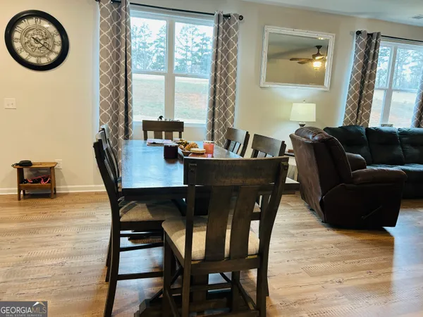 a view of a dining room with furniture and a large window