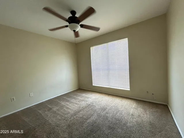 an empty room with closet and windows
