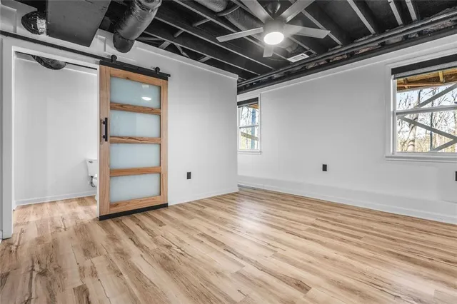 a view of empty room with wooden floor