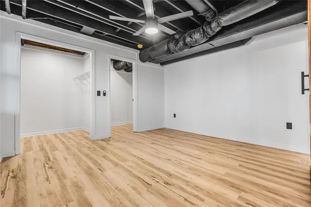 a view of empty room with wooden floor