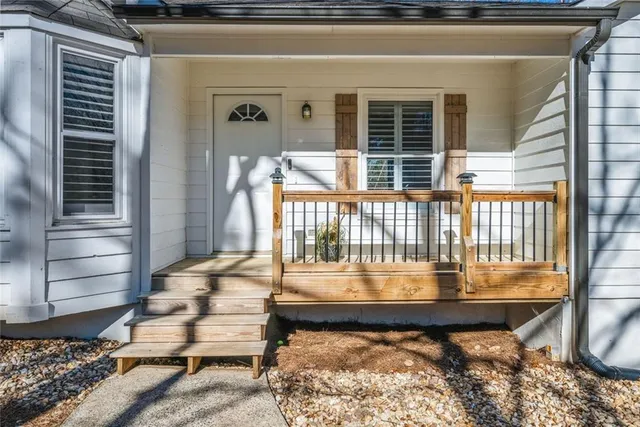 a view of a balcony with a small yard and wooden floor and fence