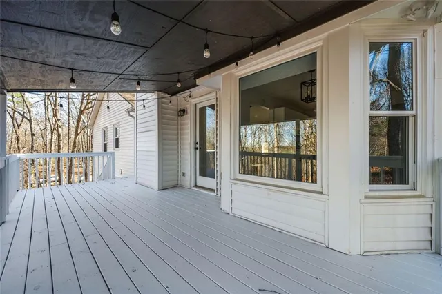 a view of outdoor space with wooden floor and windows