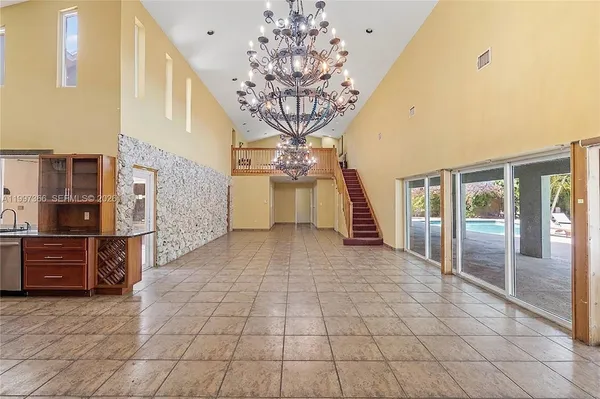 a view of entryway with a chandelier and fireplace