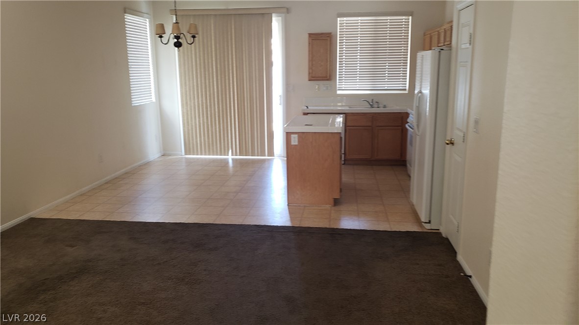 9112 Manalang Road Las Vegas, NV 89123 - Photo 29 of 50 A combined living and kitchen area features warm flooring and natural light.