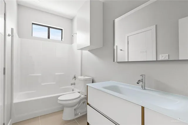 a bathroom with a toilet a sink a mirror and bathtub