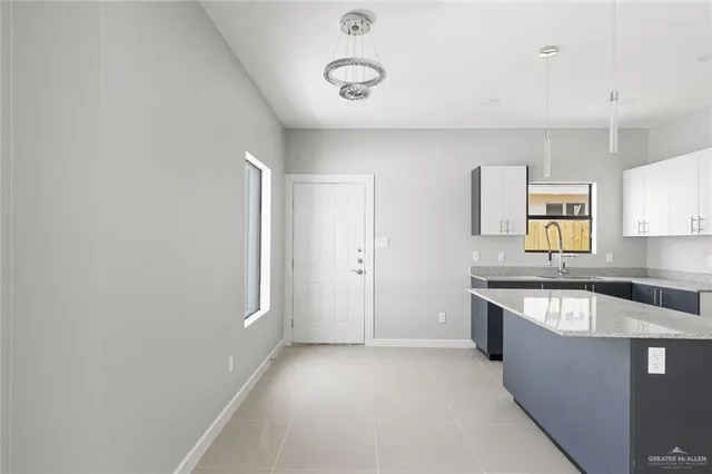 a kitchen with stainless steel appliances granite countertop a sink and a stove