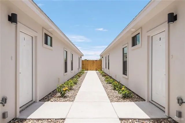 a view of a pathway along with potted plants