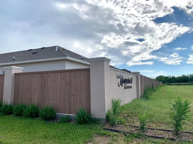 a backyard of a house with plants and a yard
