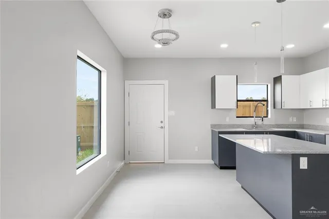 a kitchen with stainless steel appliances granite countertop a sink and a stove