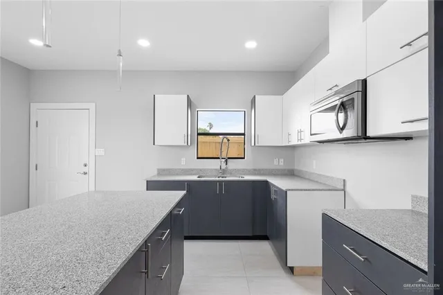 a kitchen with a sink and cabinets