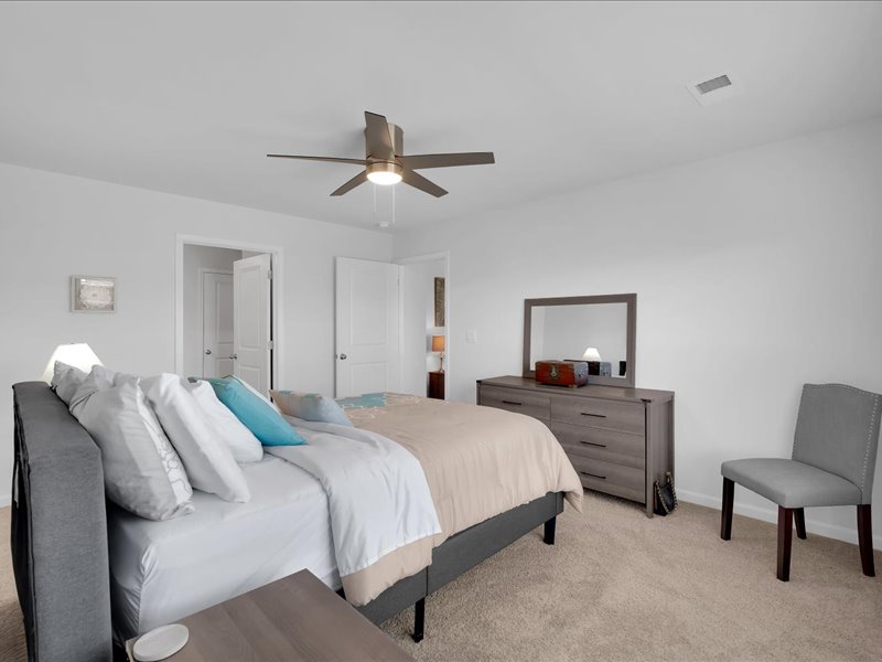 525 Ashwood Way Easley, SC 29640 - Photo 17 of 36 This spacious bedroom features a ceiling fan, plush carpet, and ample natural light.