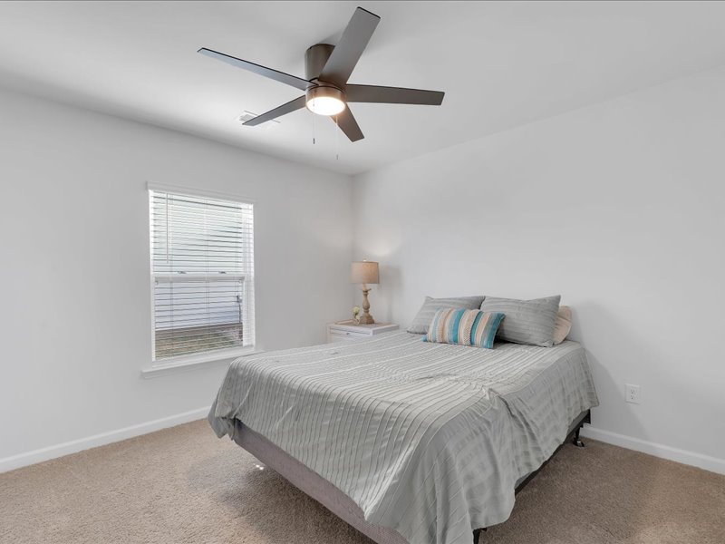 525 Ashwood Way Easley, SC 29640 - Photo 19 of 36 This cozy bedroom offers a tranquil retreat with soft lighting and comfortable carpeting.