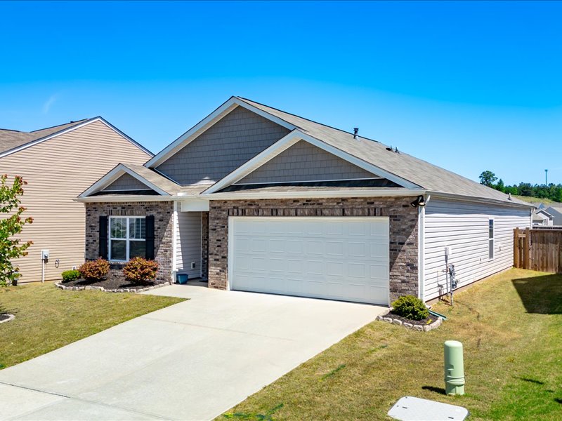 525 Ashwood Way Easley, SC 29640 - Photo 2 of 36 This residence features a blend of brick and siding, a paved driveway, and an attached garage.