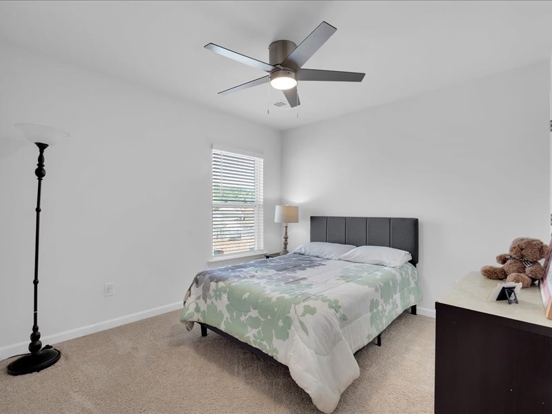 525 Ashwood Way Easley, SC 29640 - Photo 21 of 36 This spacious bedroom offers ample natural light and comfortable carpeting, creating a serene retreat.