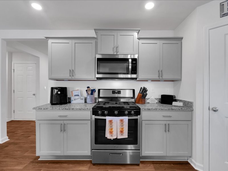 525 Ashwood Way Easley, SC 29640 - Photo 9 of 36 This modern kitchen features sleek cabinetry and essential appliances for daily living.