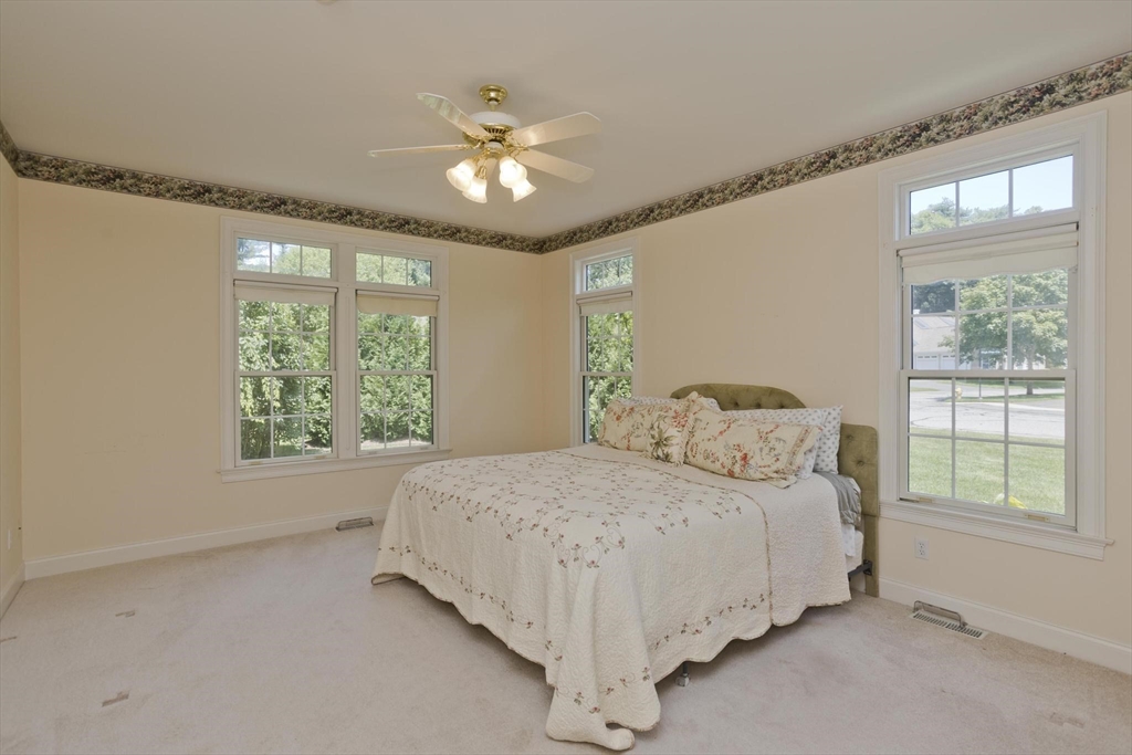 28 High Pine Circle, Unit 28 Wilbraham, MA 01095 - Photo 13 of 38 a bedroom with a large bed and a chandelier
