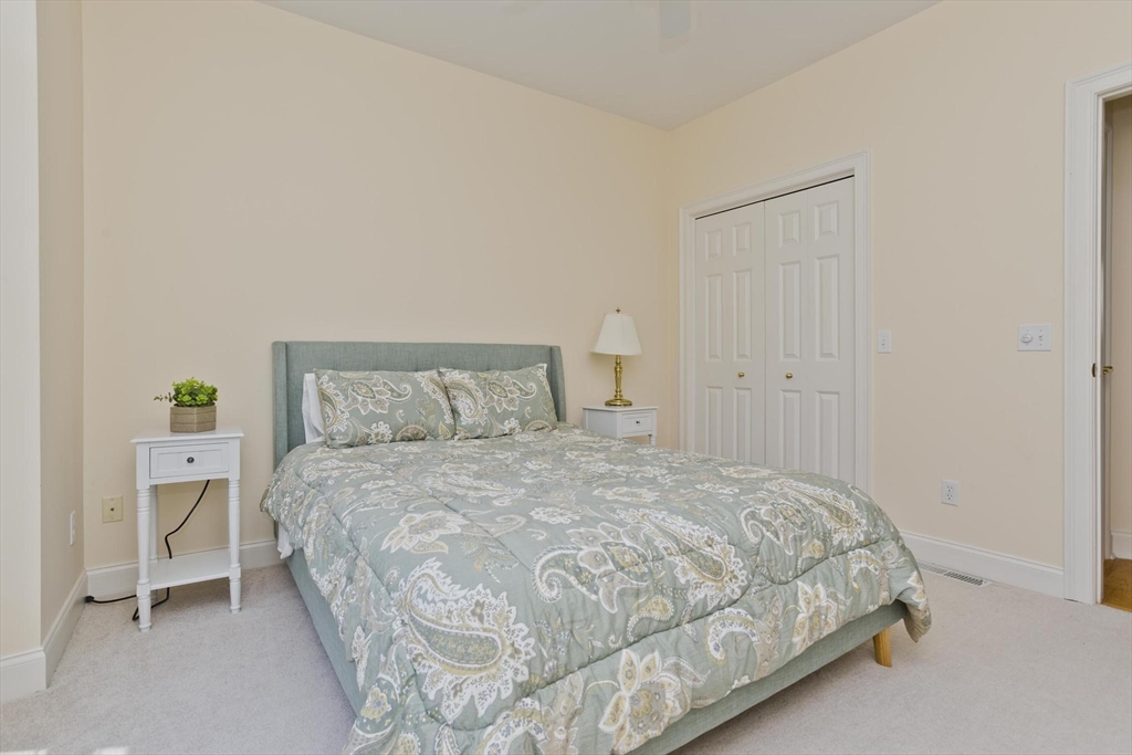 28 High Pine Circle, Unit 28 Wilbraham, MA 01095 - Photo 19 of 38 a bedroom with a bed and a table