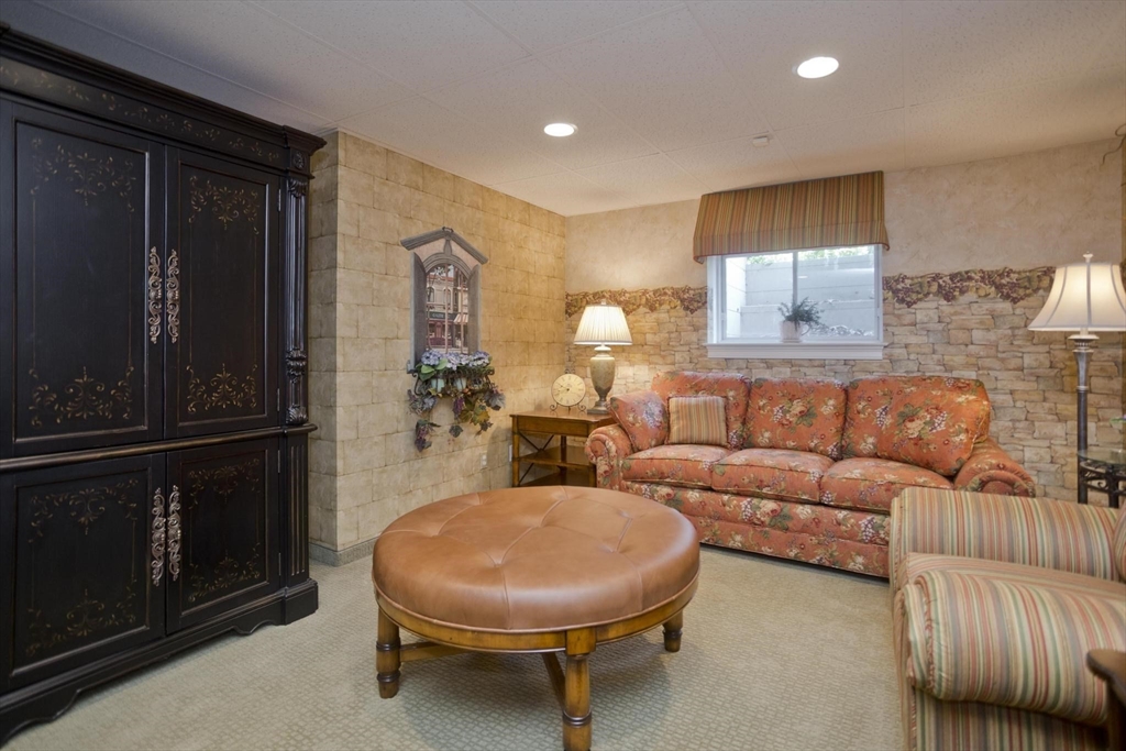 28 High Pine Circle, Unit 28 Wilbraham, MA 01095 - Photo 26 of 38 a living room with furniture a lamp and a window