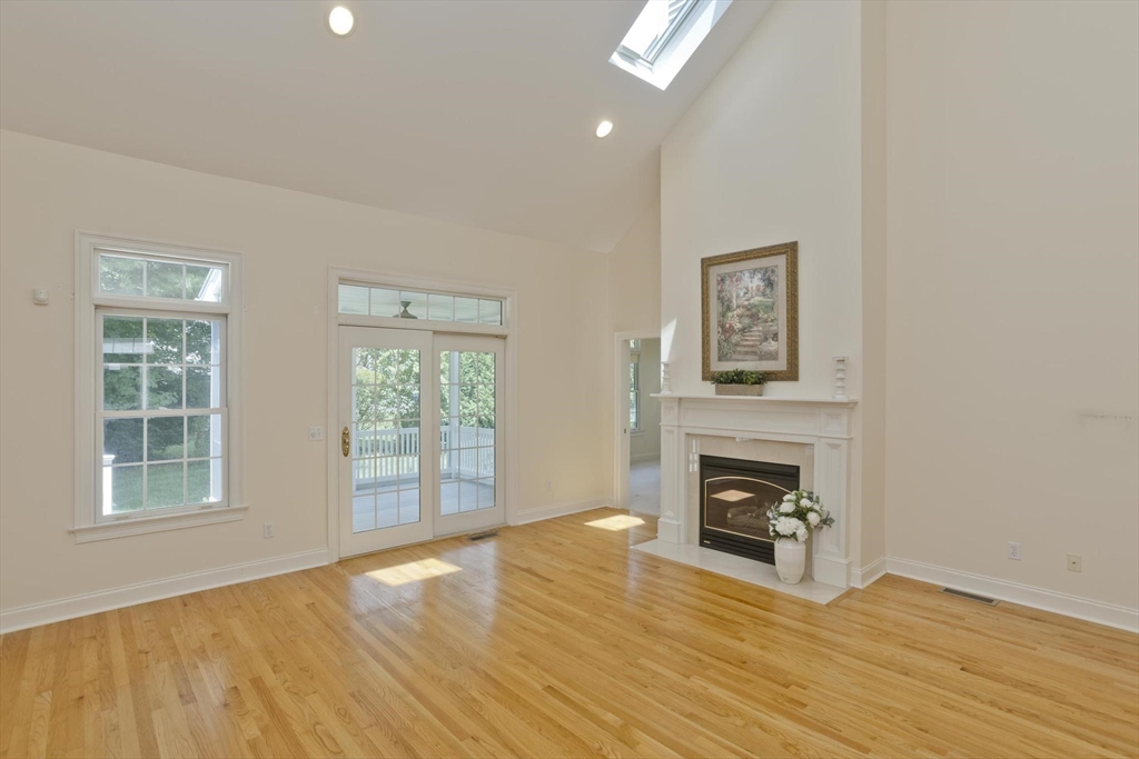 28 High Pine Circle, Unit 28 Wilbraham, MA 01095 - Photo 3 of 38 a view of livingroom with furniture a fireplace and wooden floor