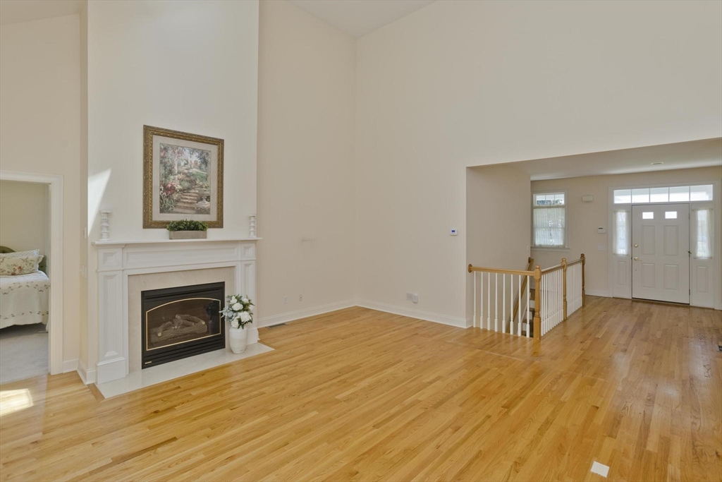 28 High Pine Circle, Unit 28 Wilbraham, MA 01095 - Photo 4 of 38 a view of empty room with wooden floor and fireplace