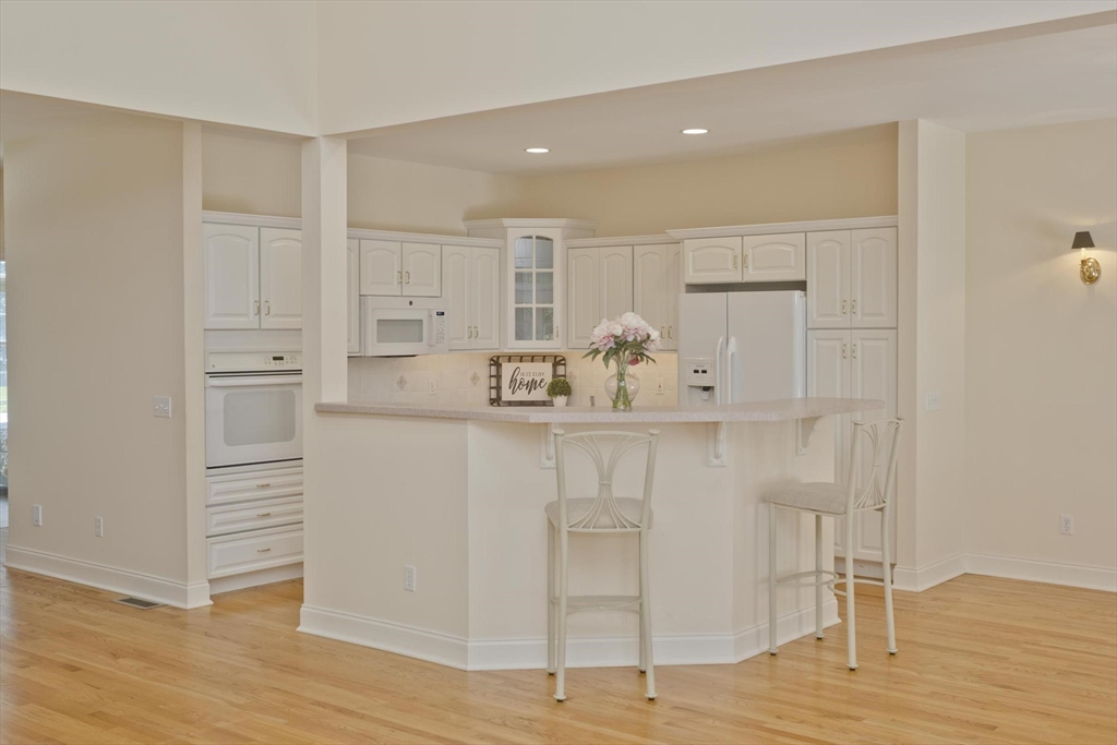 28 High Pine Circle, Unit 28 Wilbraham, MA 01095 - Photo 6 of 38 a room with white cabinets and wooden floor