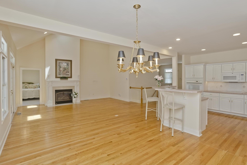 28 High Pine Circle, Unit 28 Wilbraham, MA 01095 - Photo 9 of 38 a view of a kitchen with furniture and wooden floor