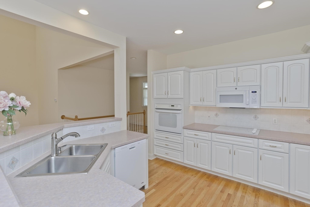 28 High Pine Circle, Unit 28 Wilbraham, MA 01095 - Photo 10 of 38 a kitchen with white cabinets sink and white appliances