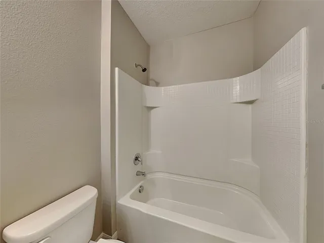 a bathroom with a bathtub and toilet