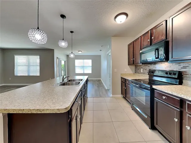 a kitchen with a counter space cabinets and appliances