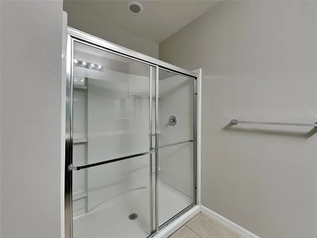 a bathroom with a glass shower door