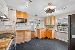 a kitchen with stainless steel appliances granite countertop a sink and dishwasher a stove top oven with a dishwasher