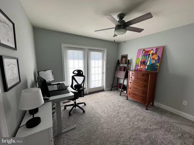 a living room with furniture and a lamp