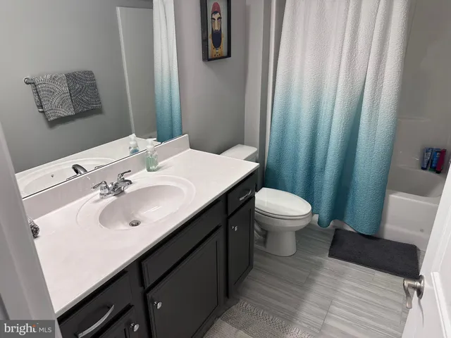 a bathroom with a sink a toilet and mirror
