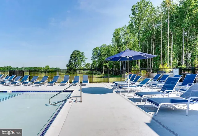 a view of a patio with swimming pool and outdoor seating