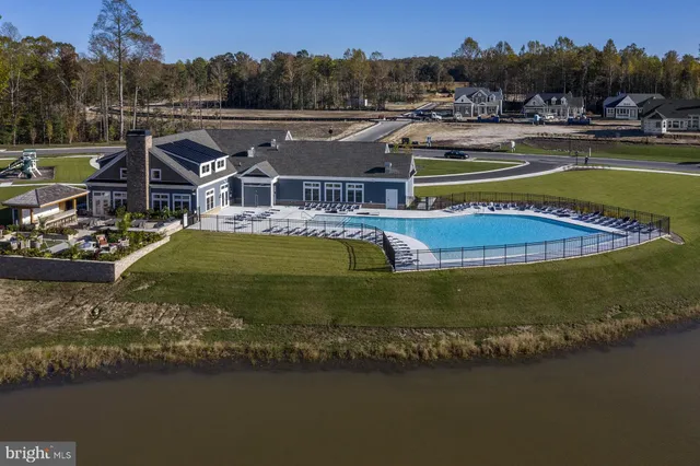 a view of a swimming pool with lounge chairs in patio