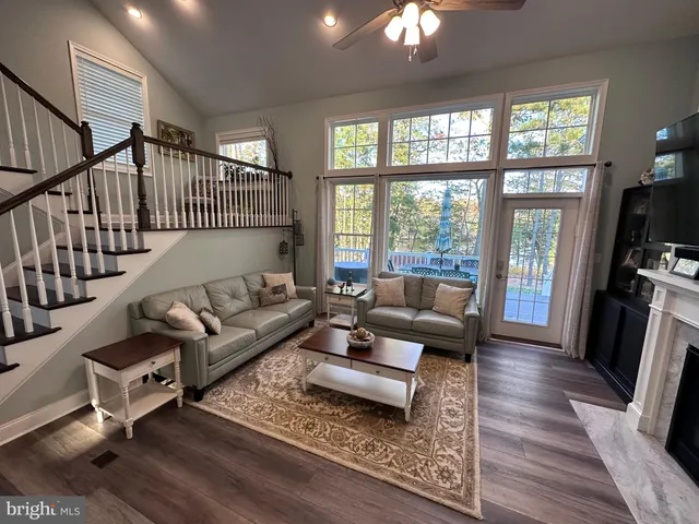 a living room with furniture wooden floor and a flat screen tv